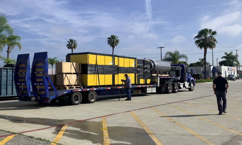 Industrial compressor delivered on flatbed truck for installation